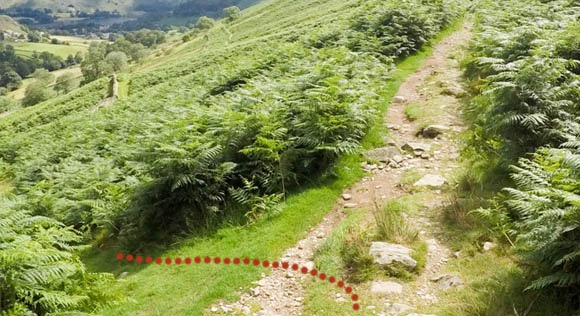 Left turn towards stone wall